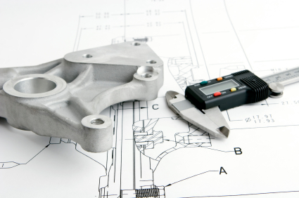 machined part with digital calipers on drawing